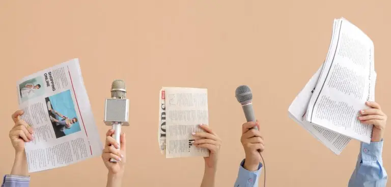 Female,Hands,With,Microphones,And,Newspapers,On,Beige,Background